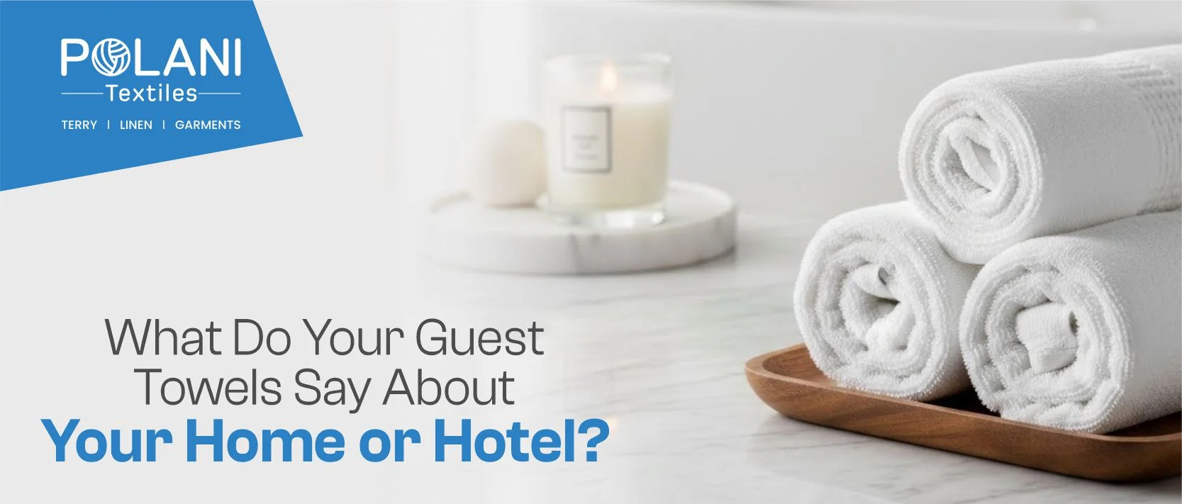 Rolled white towels on tray with lit candle.