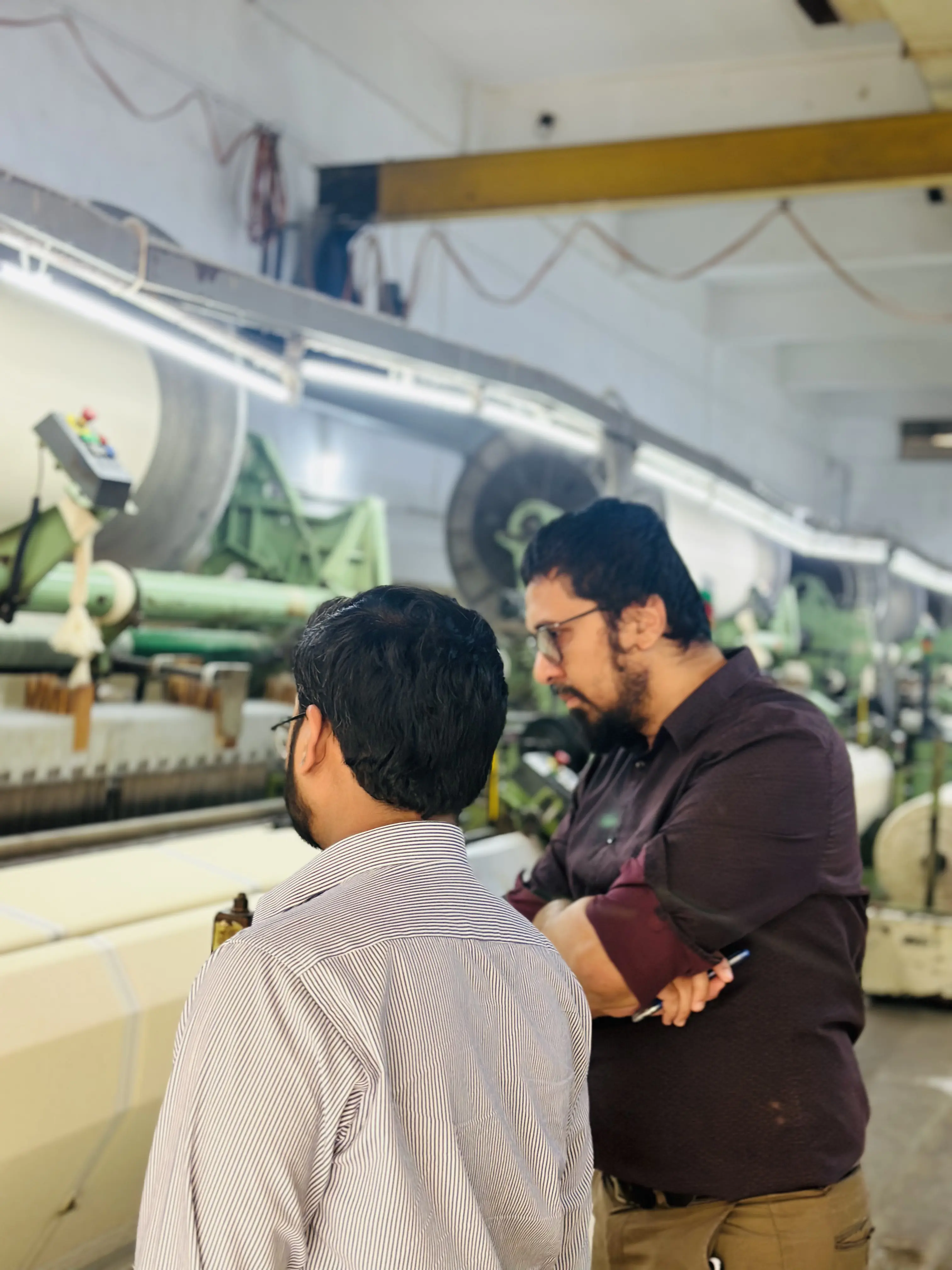 polani team inspecting loom machine in training session