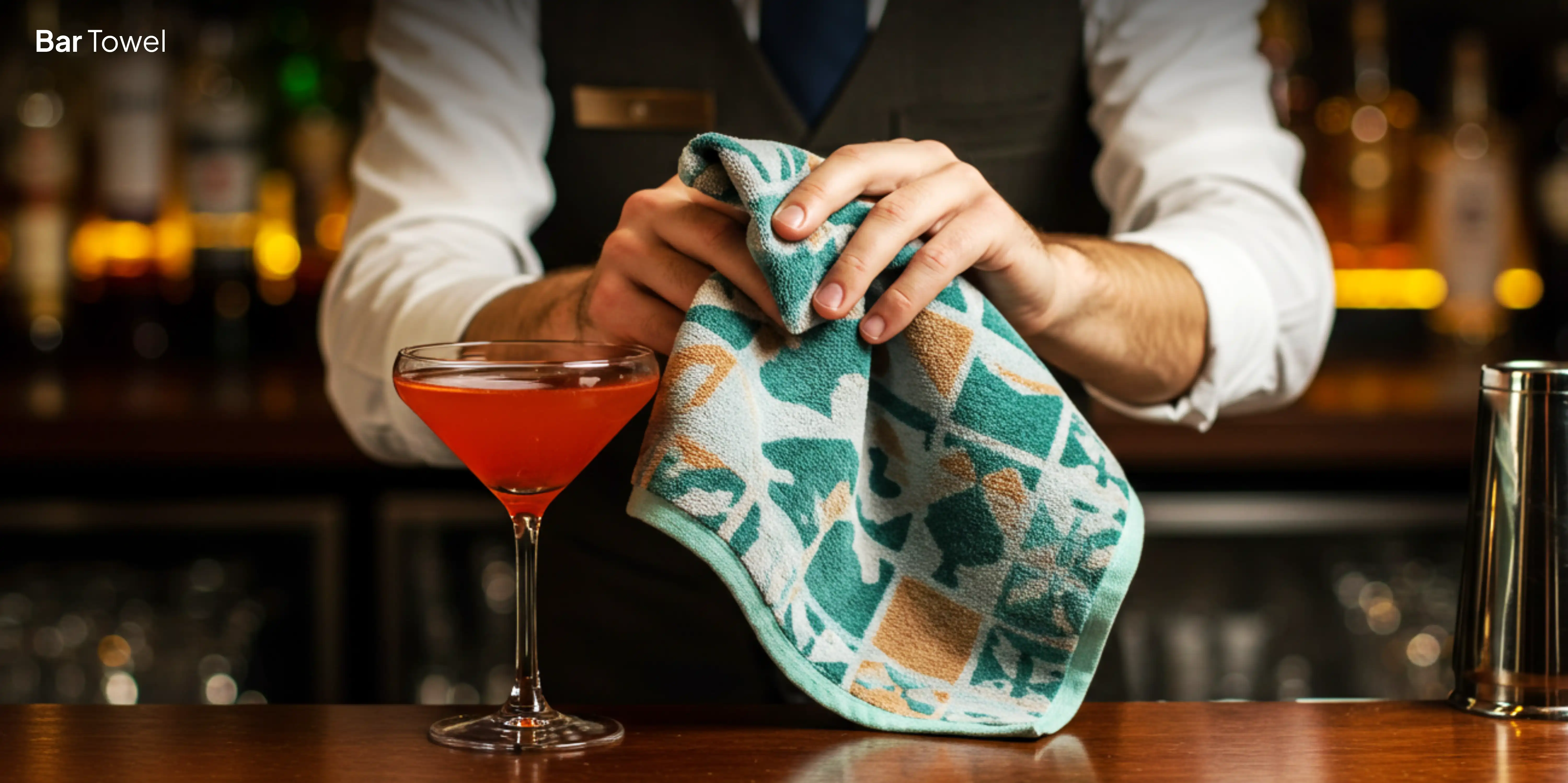 bartender cleaning bar with patterned towel
