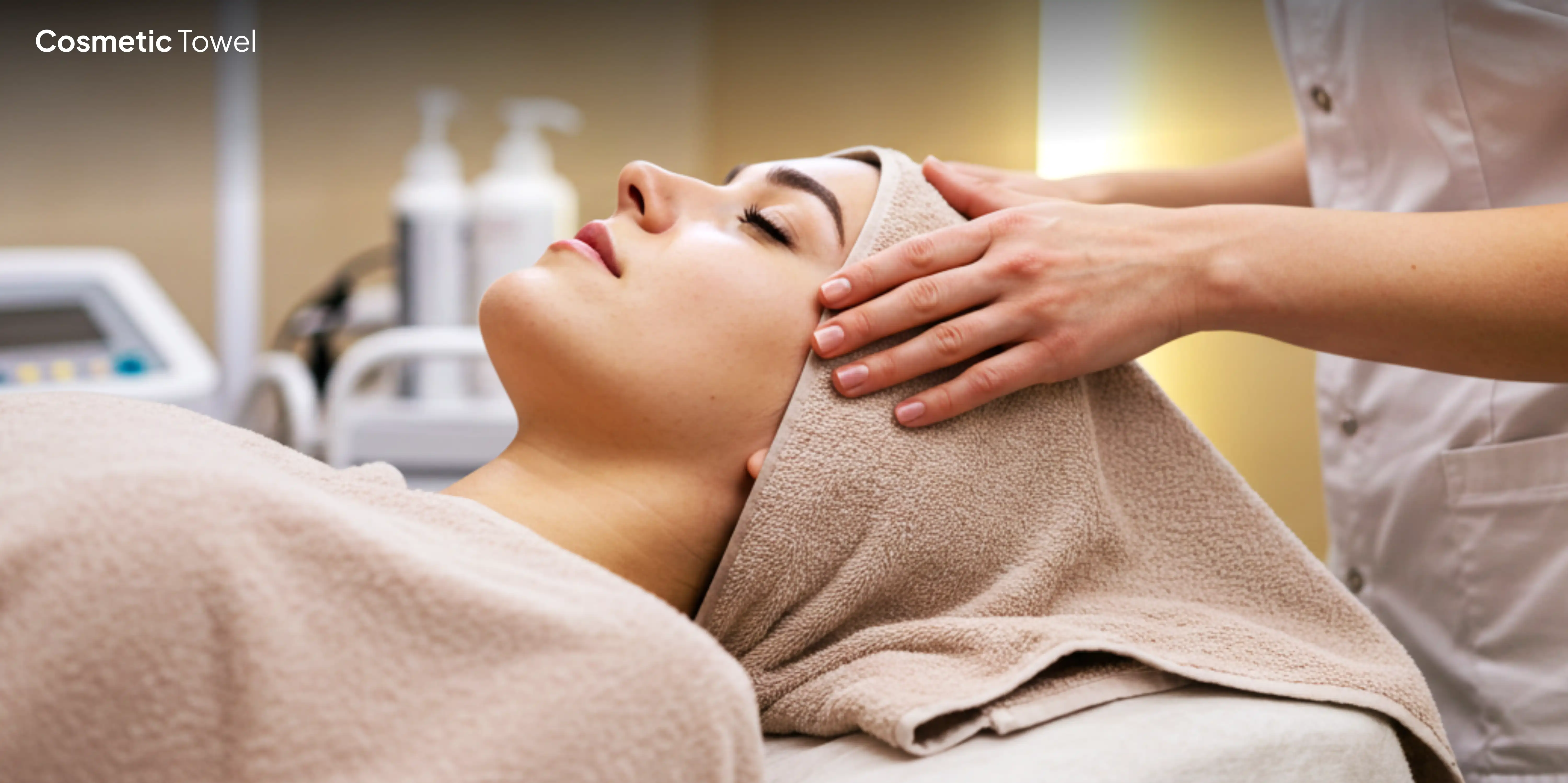 Woman receiving facial over brown towel.