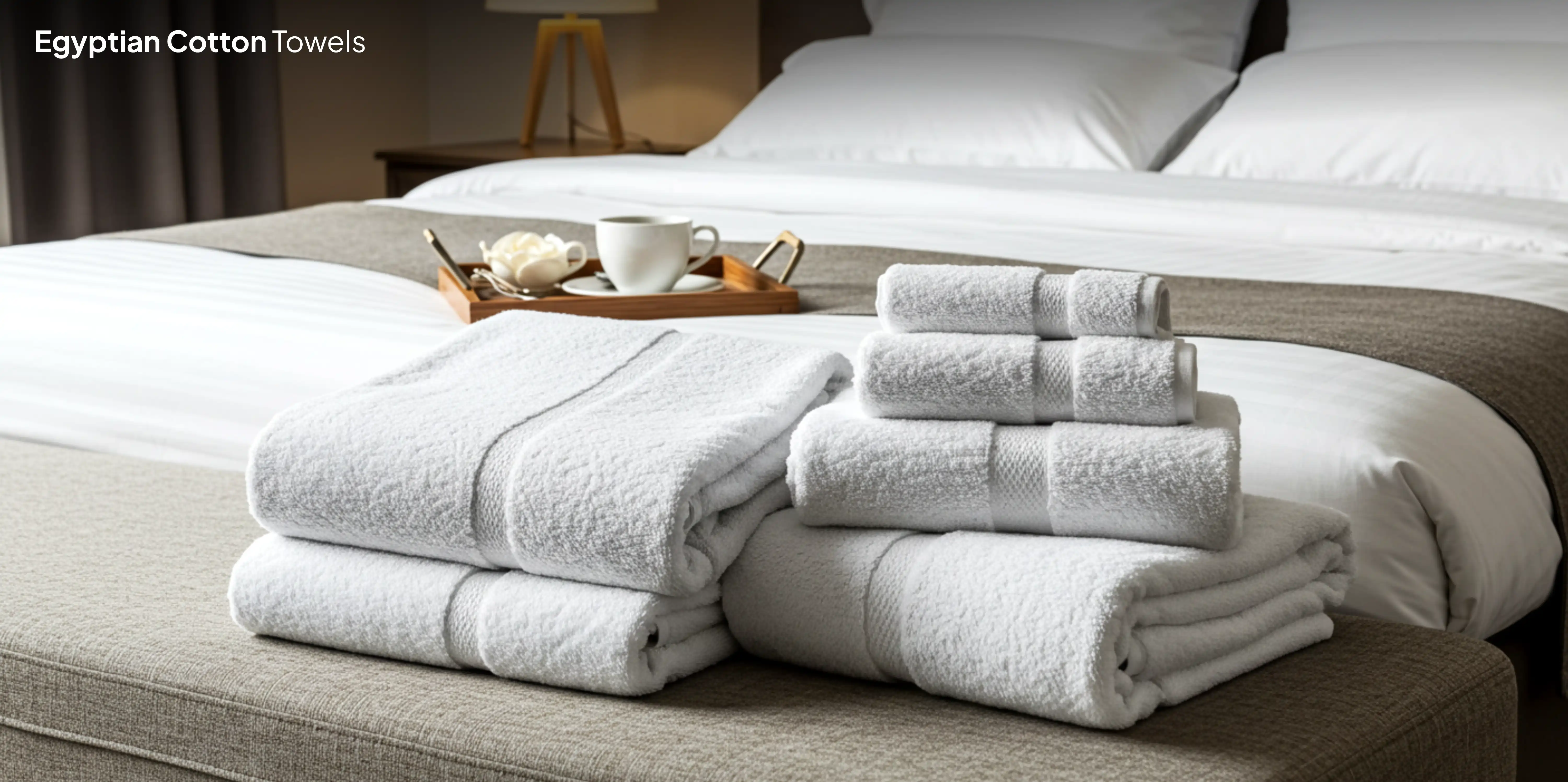White Egyptian cotton towels on gray ottoman.