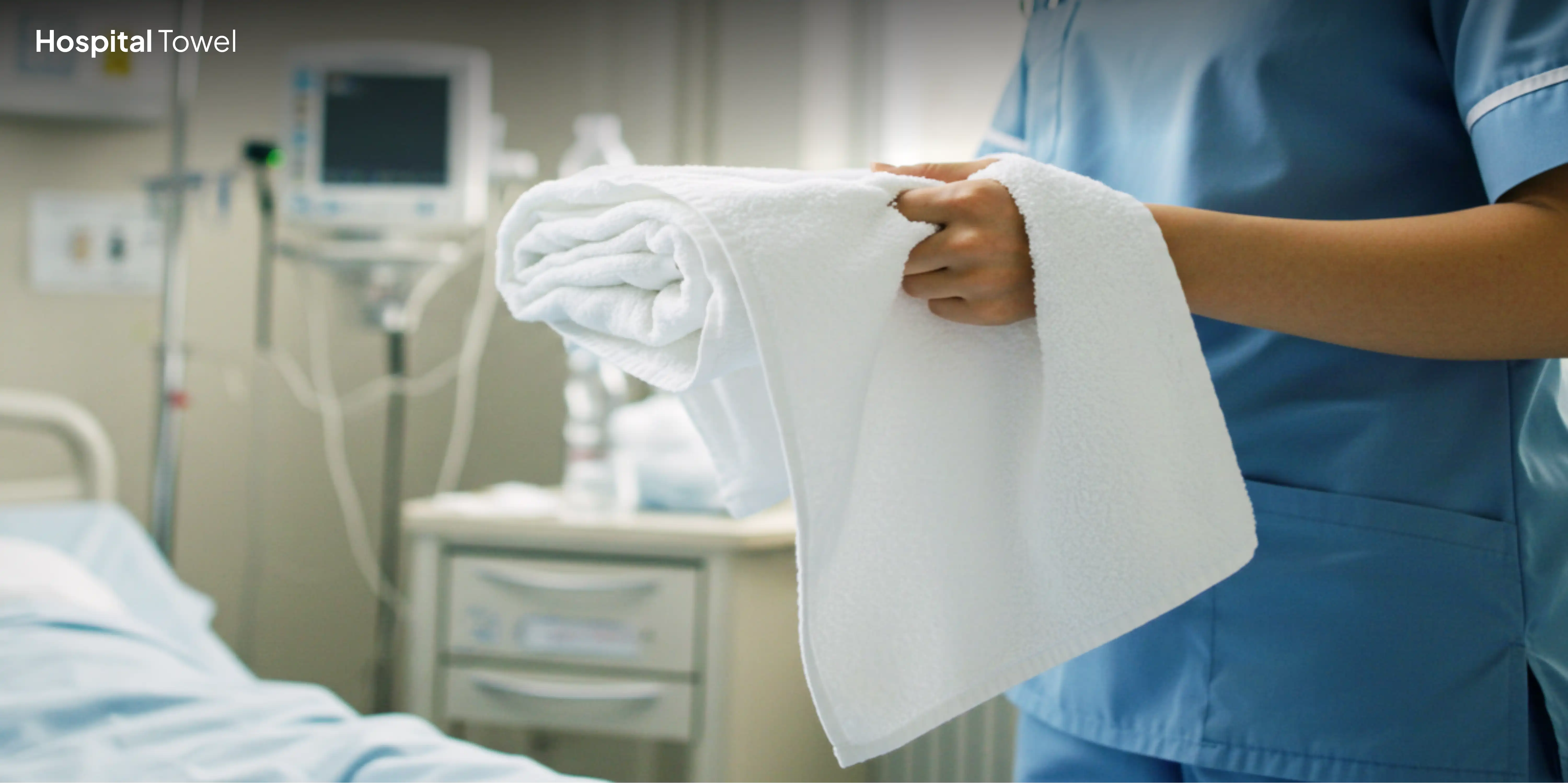 Person in scrubs holding folded hospital towel.