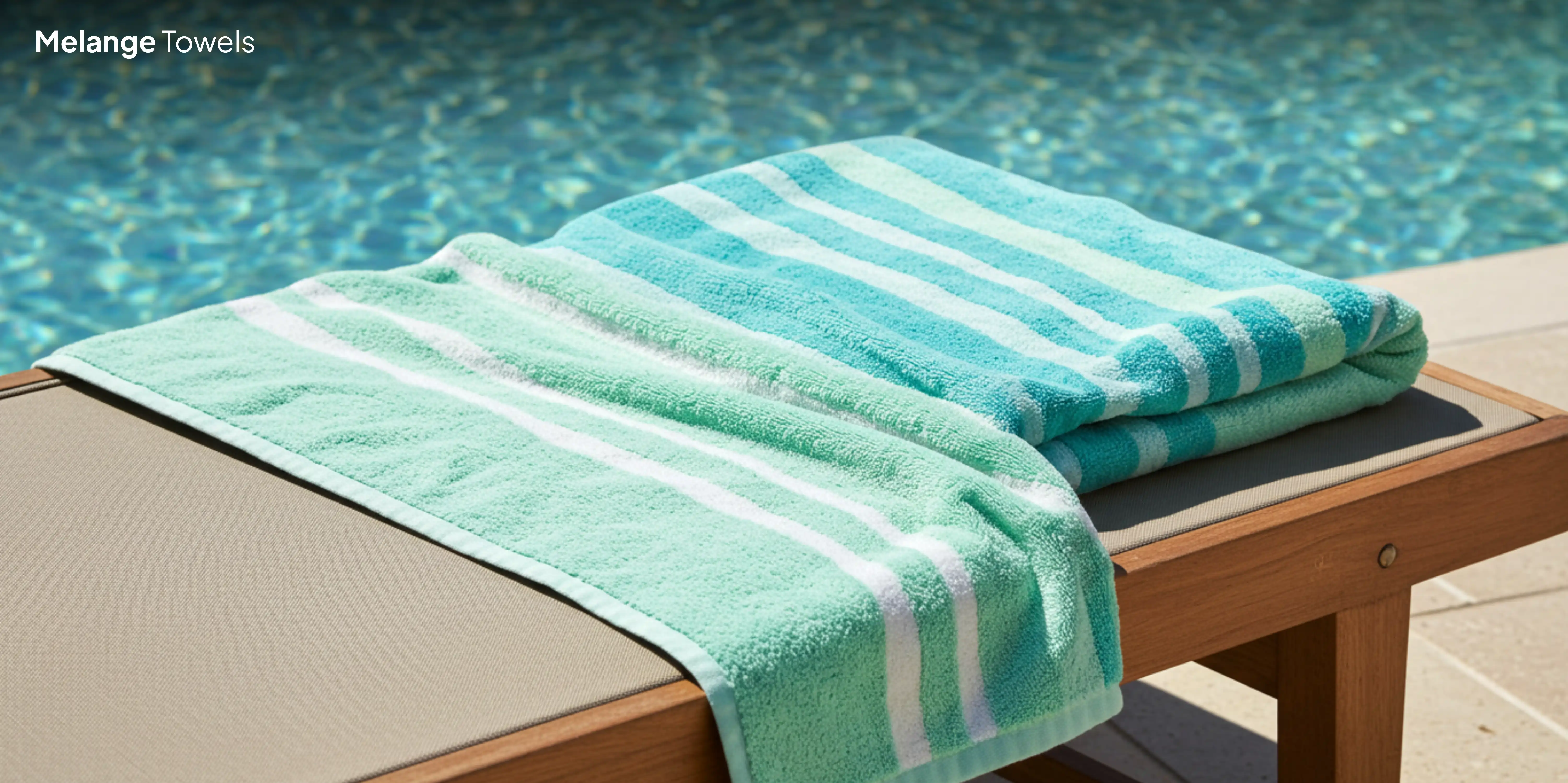 Turquoise striped towel on pool lounger.
